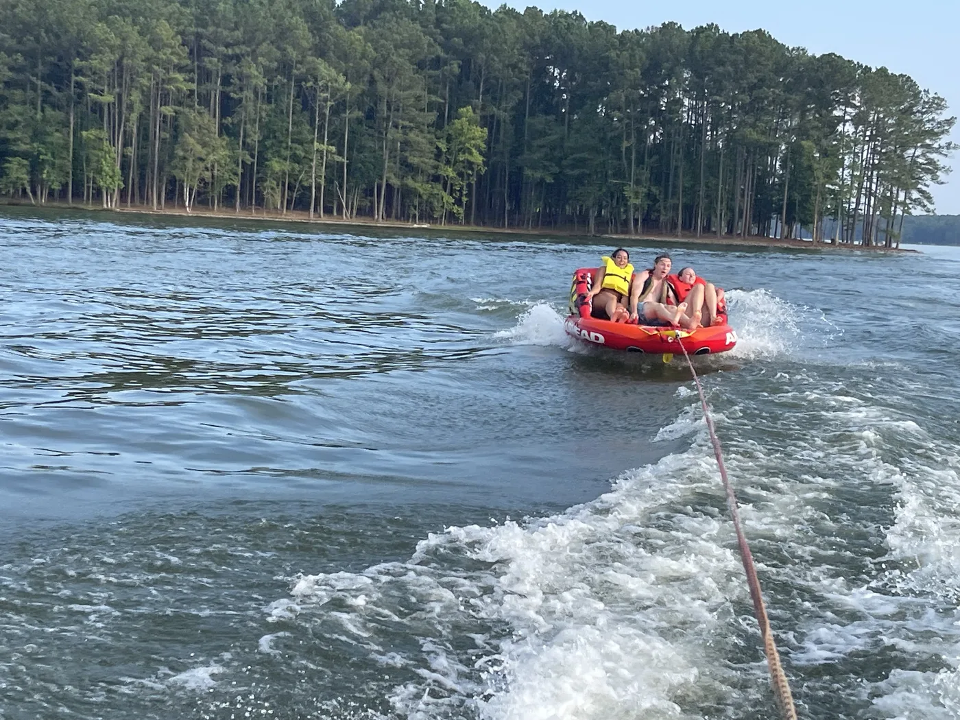 Tubing behind a boat on Lake Oconee in summer